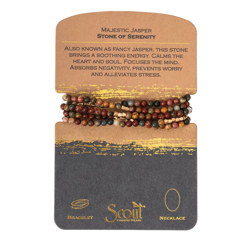 A bracelet made with semi precious stone beads in various colors, wrapped on a cardboard backing with text describing the product as 'Majestic Jasper | Stone of Serenity'.