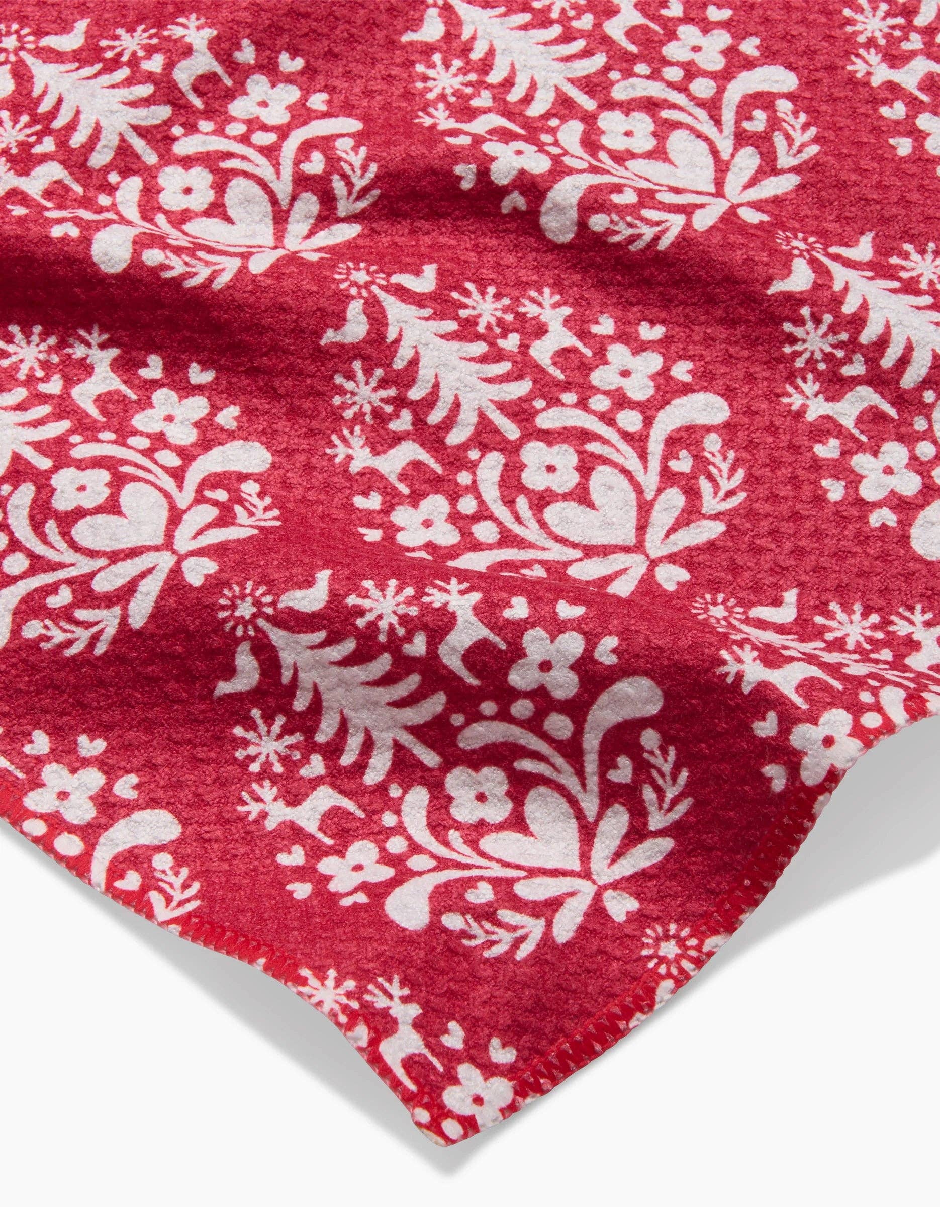 Close-up of a red bar towel with a white geometric pattern.