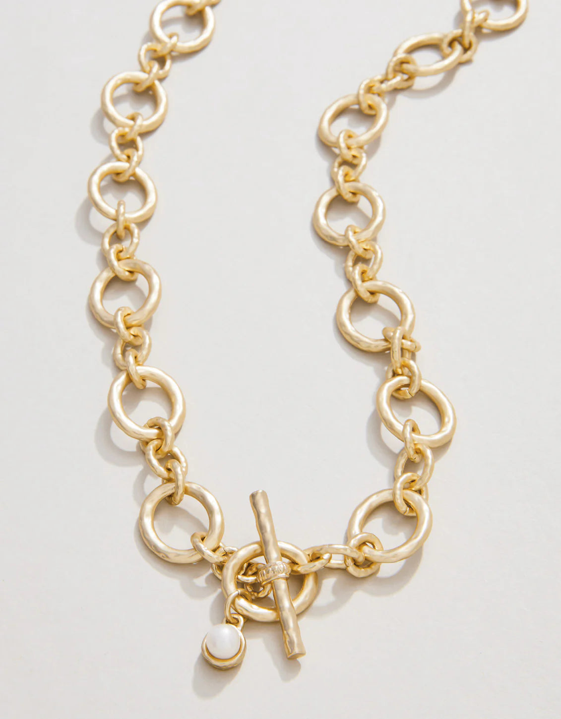 A gold chain toggle necklace with a length of 18 inches.
