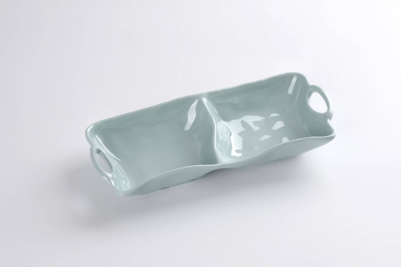 Light blue ceramic tray with handles on a white background