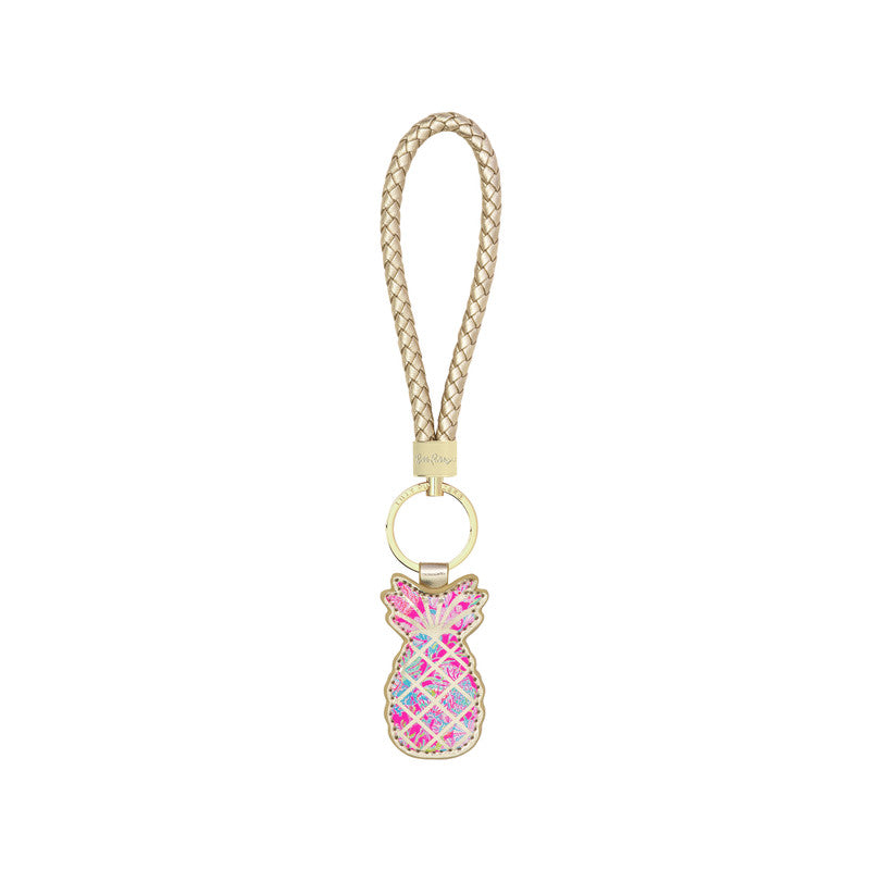 A multicolored wristlet keychain in the shape of a pineapple with a gold key ring and a printed leatherette strap.