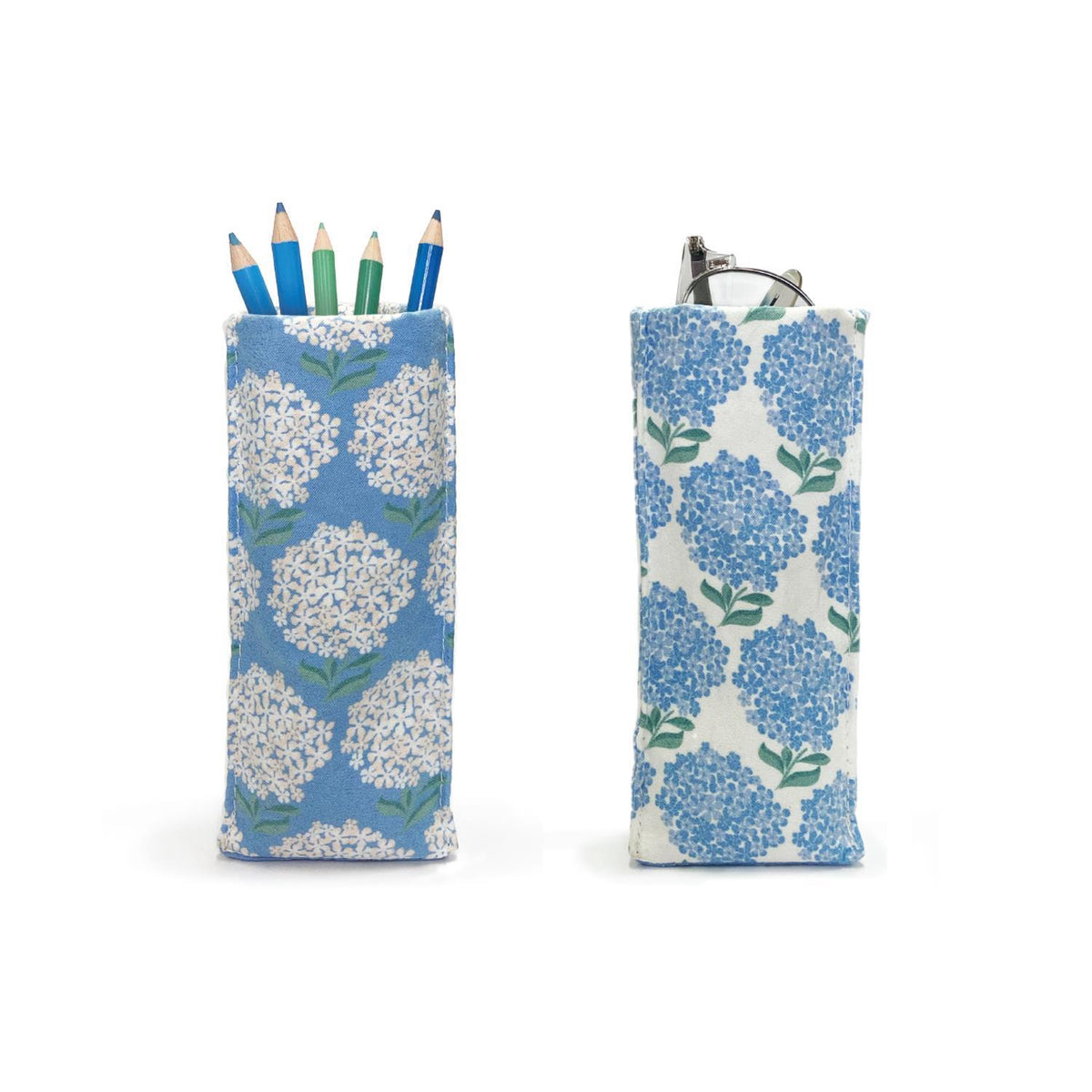 Two blue and white floral pencil holders with pencils on a white background