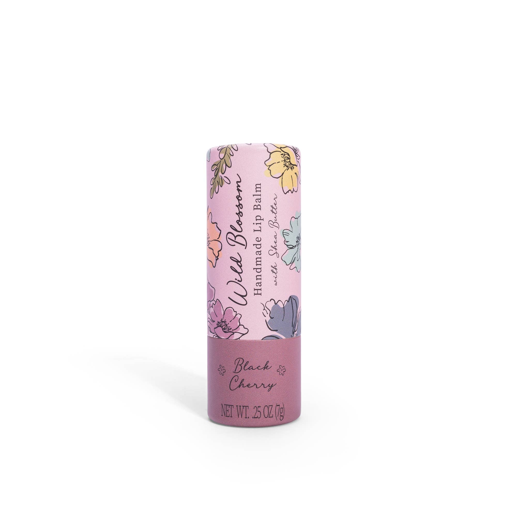 A tube of Wild Blossom Lip Balm in Black Cherry flavor, with floral designs and the brand name 'Cait + Co' visible.