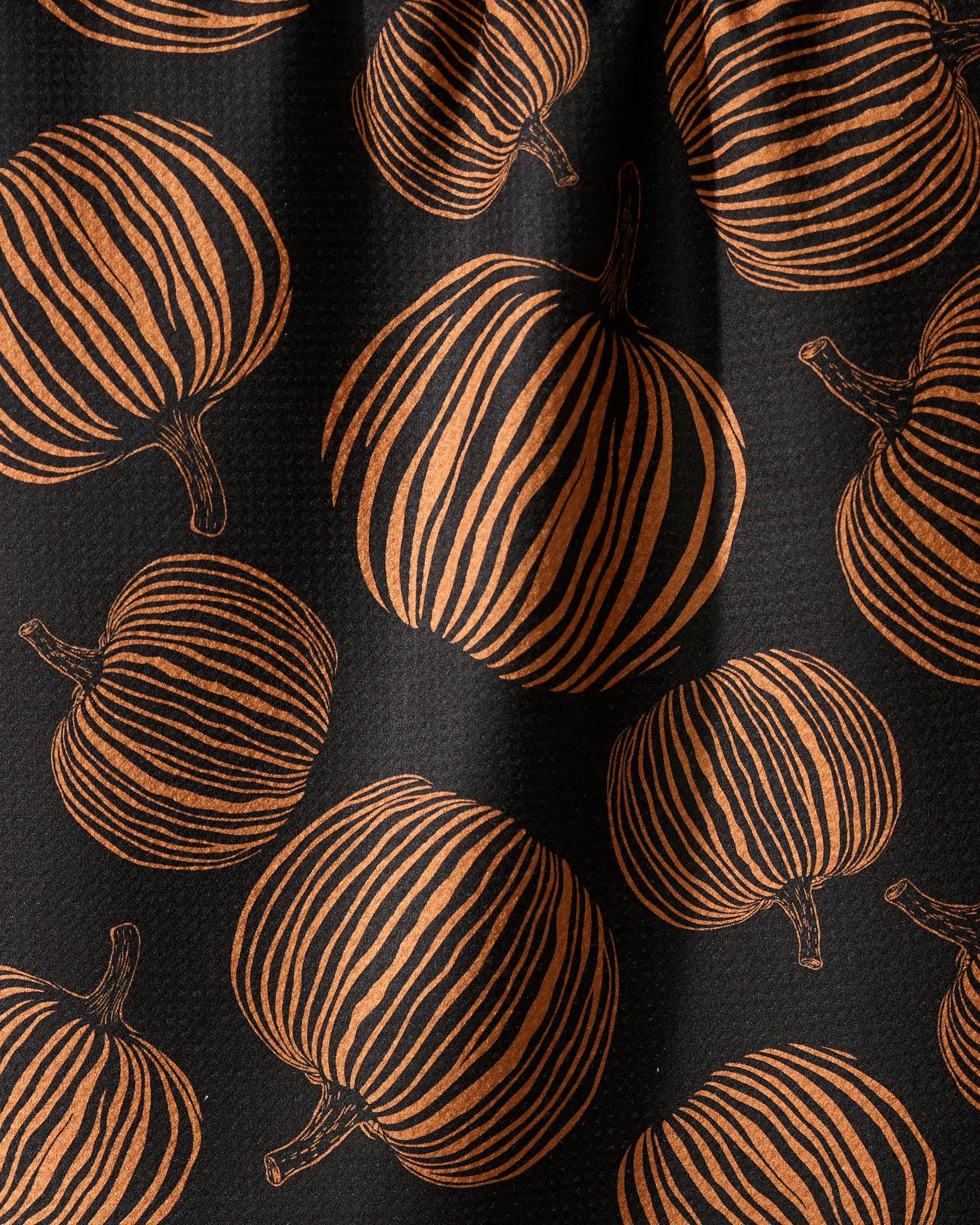 Pattern of brown pumpkins on a black background