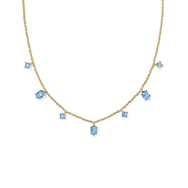 A delicate gold chain necklace featuring seven light blue gemstones of various shapes, including marquise, pear, and square settings, displayed against a solid white background.