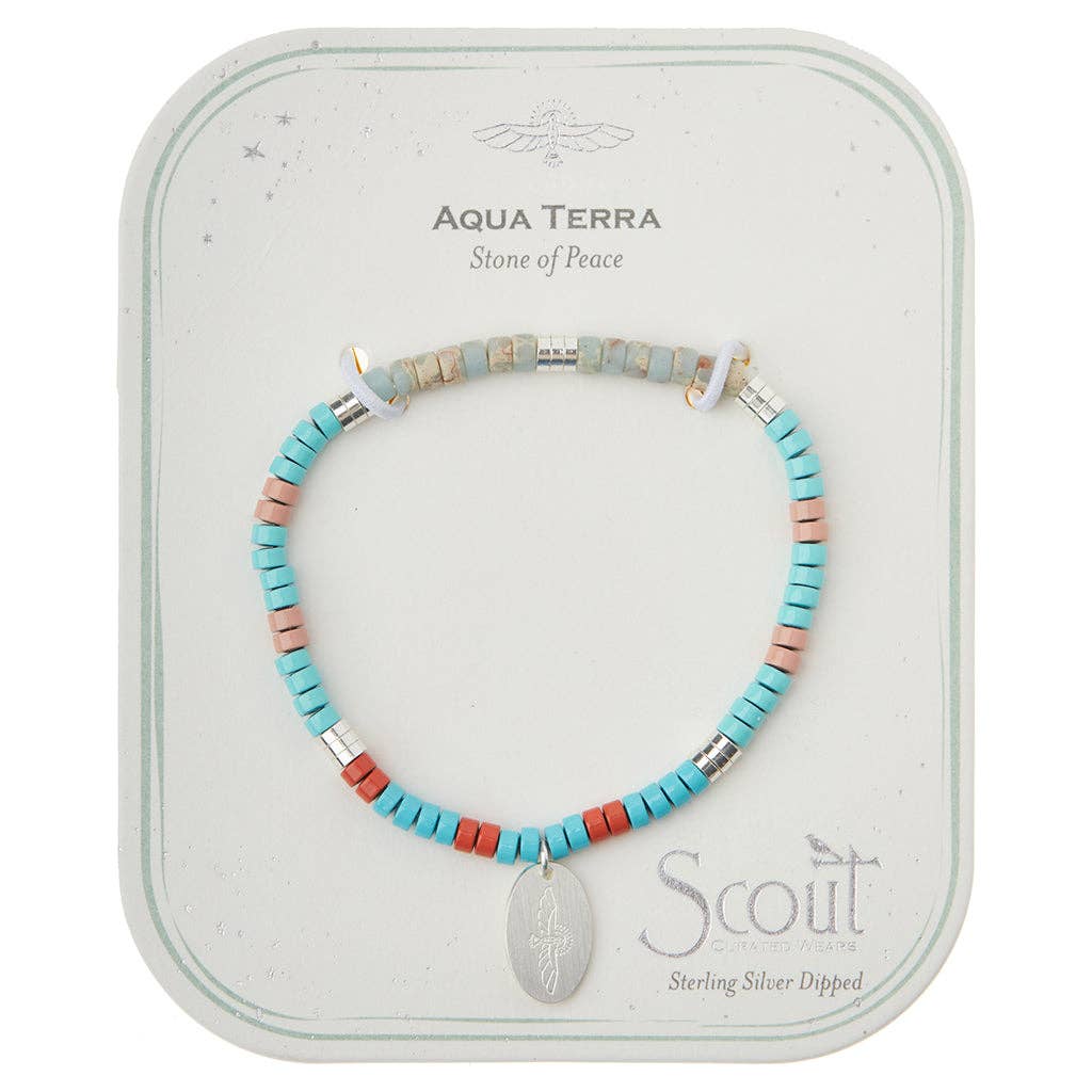 A bracelet with a mix of blue, white, and red semi-precious stone beads, and silver-dipped charms, presented on a card with 'Aqua Terra' and 'Stone of Peace' text.