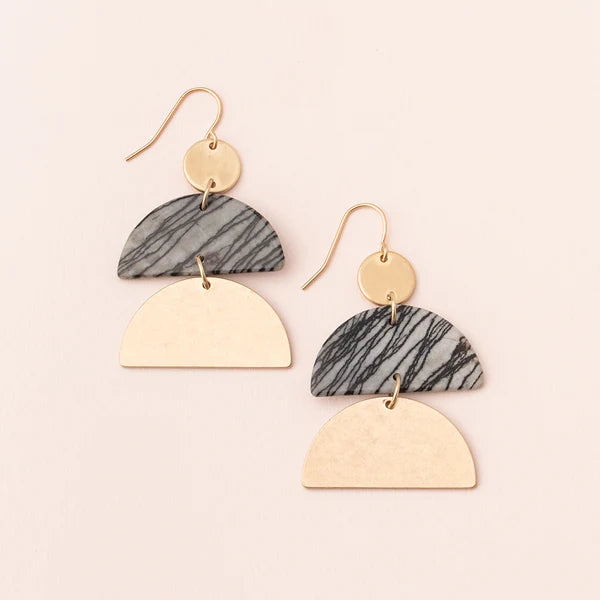 Pair of earrings with gold and marbled gray design on a beige background