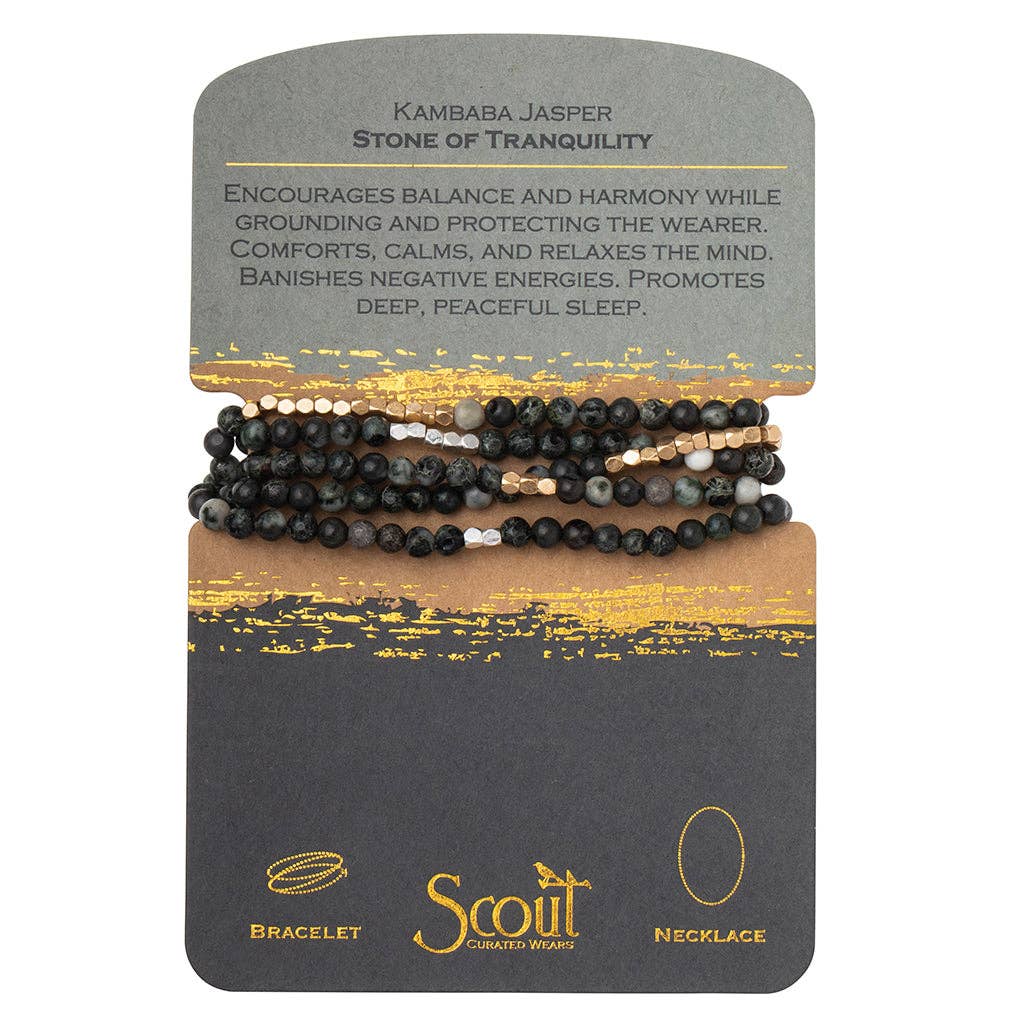 A bracelet made with black and gray semi-precious stone beads, plated brass, and stretch cord, packaged on a card with 'Kambaba Jasper - Stone of Tranquility' text and branding.