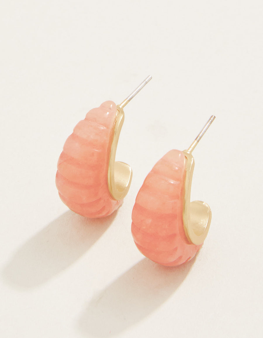 A pair of hoop earrings with carved pink dyed jade and 18kt matte gold plating.