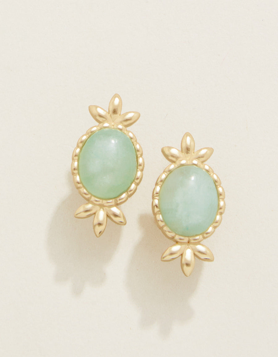 A pair of oval-shaped stud earrings with gold plating and seafoam green jade stones.