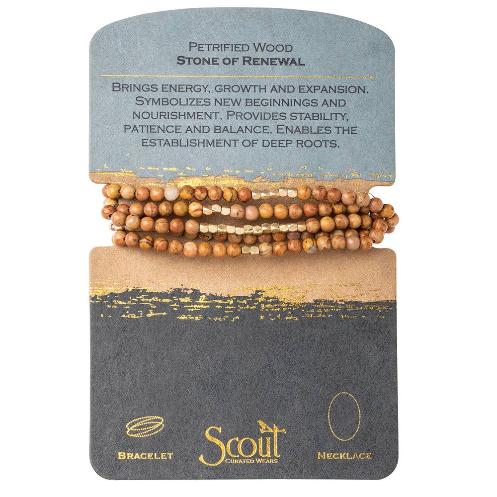 A Petrified Wood bracelet wrapped around a card with the text 'Petrified Wood - Stone of Renewal', bringing energy, growth and expansion. The card also features a symbol and the brand 'Scout'.