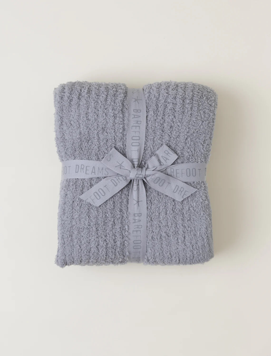 A ribbed knit throw blanket in dove grey with a bow detail, displayed on a plain background.