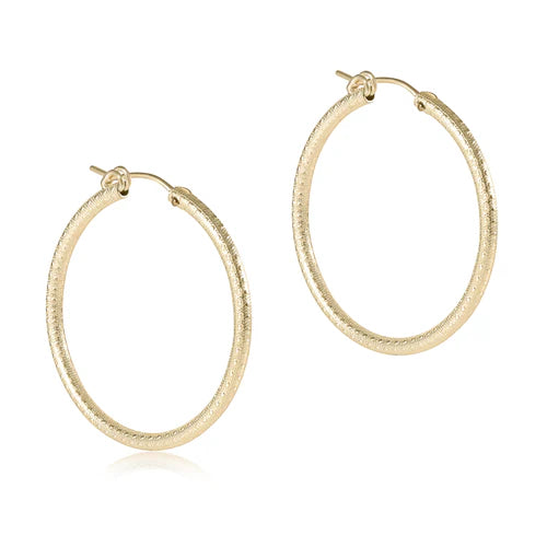 A pair of round, gold-colored hoop earrings with a notch clasp, displayed against a white background.