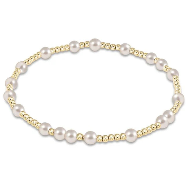 Pearl bracelet with gold accents on a white background