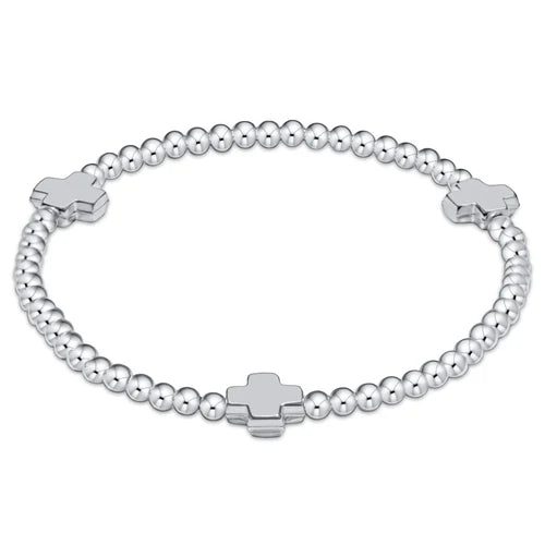 Silver beaded bracelet with cross charms on a white background