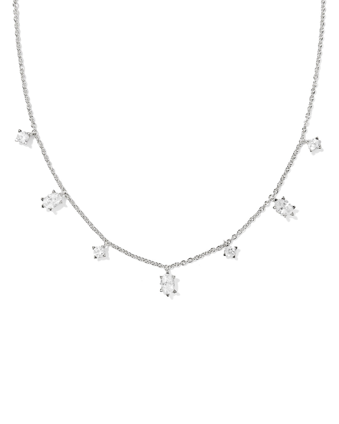 A silver-toned necklace featuring a delicate chain with multiple small clear gemstone clusters spaced along the front, displayed against a plain white background.
