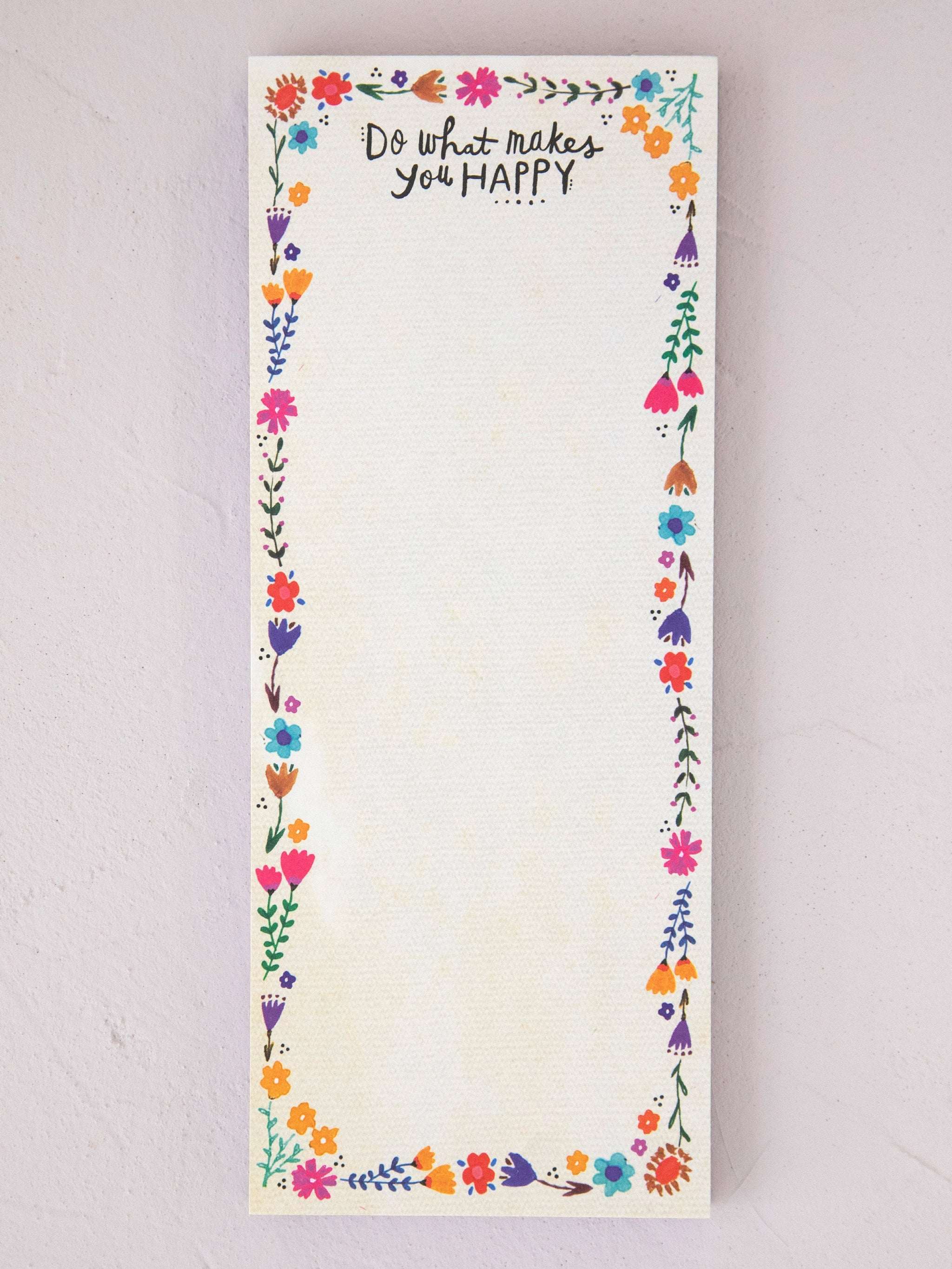 Notepad with floral border and motivational quote on a light gray background