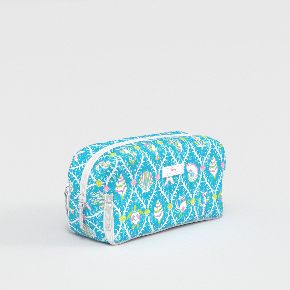 Blue toiletry bag with colorful pattern on a light gray background