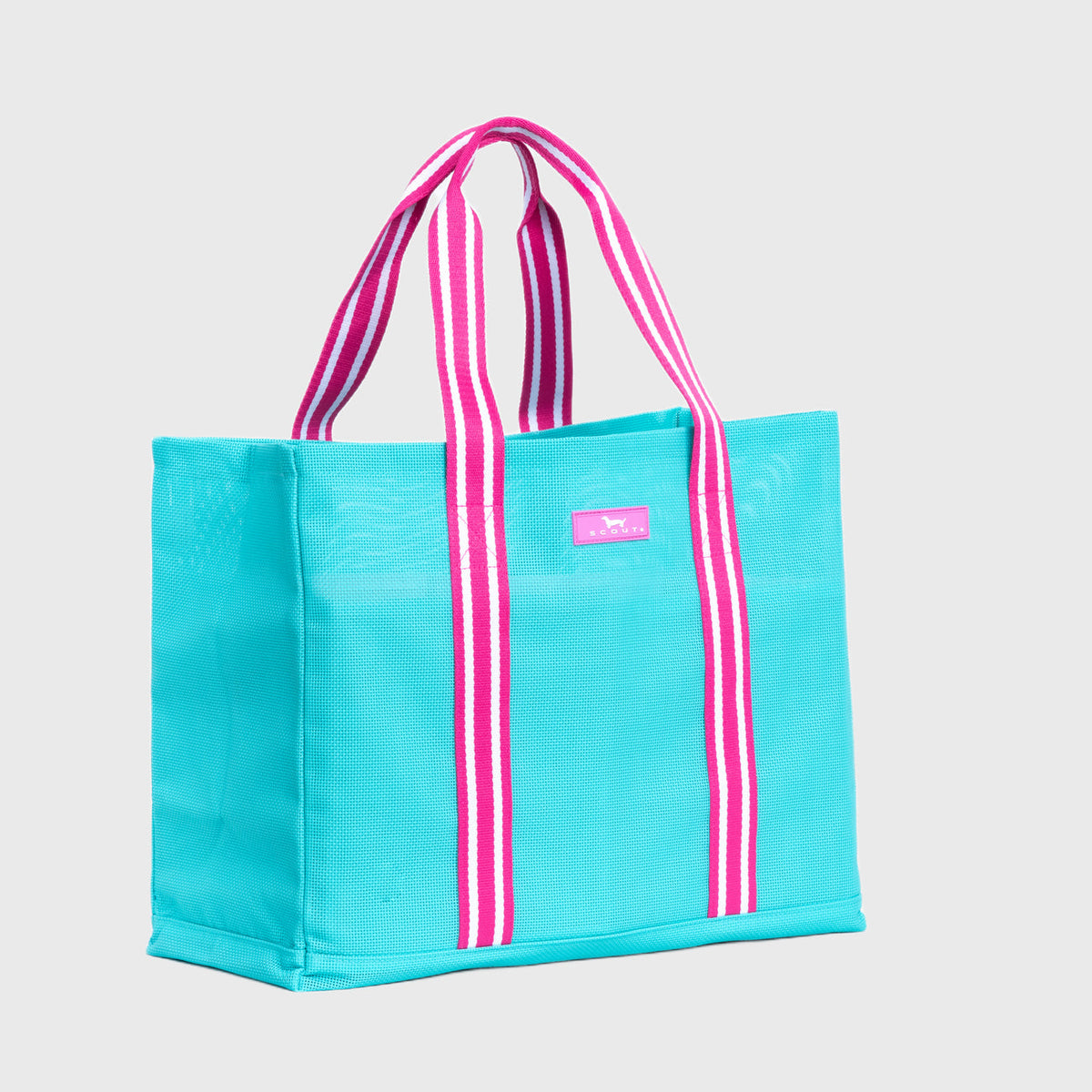 Turquoise tote bag with pink and white striped handles on a light gray background