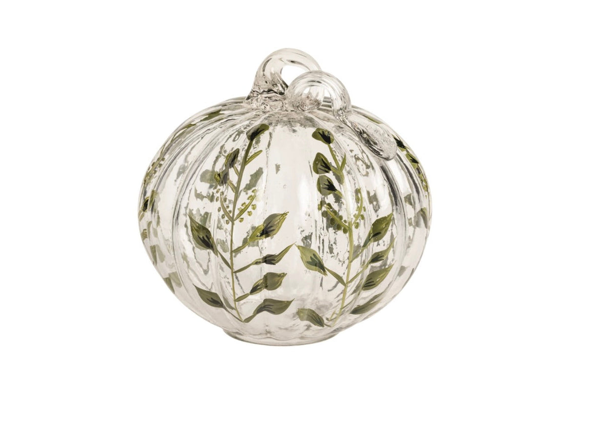 A clear glass pumpkin-shaped ornament decorated with hand-painted green botanical leaf and vine patterns, shown against a plain white background.