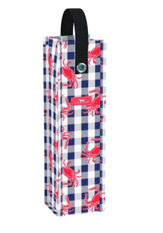 A person holding a folded black wine carrier bag with a gold and white striped pattern, presumably made of fabric.