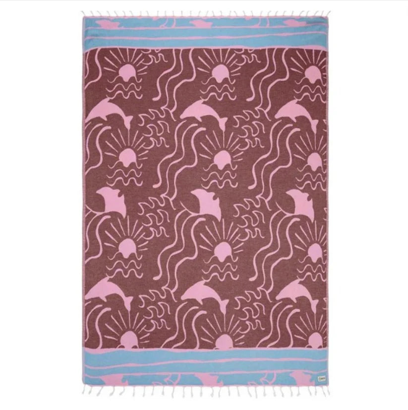 A large beach towel with a geometric pattern in shades of brown, seaglass blue, and white, featuring twisted tassels along the edges.