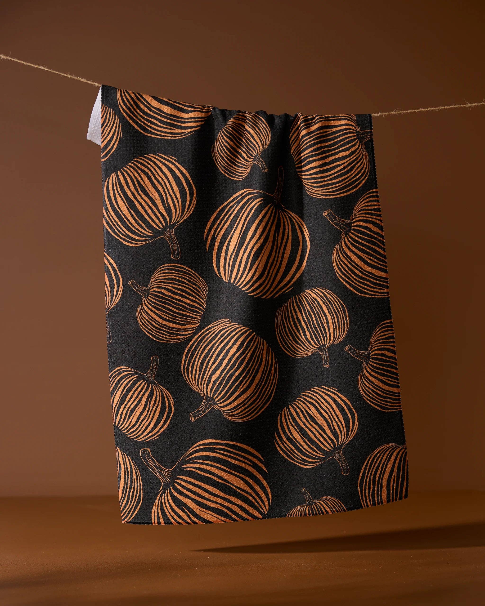 Towel with pumpkin pattern on a brown background
