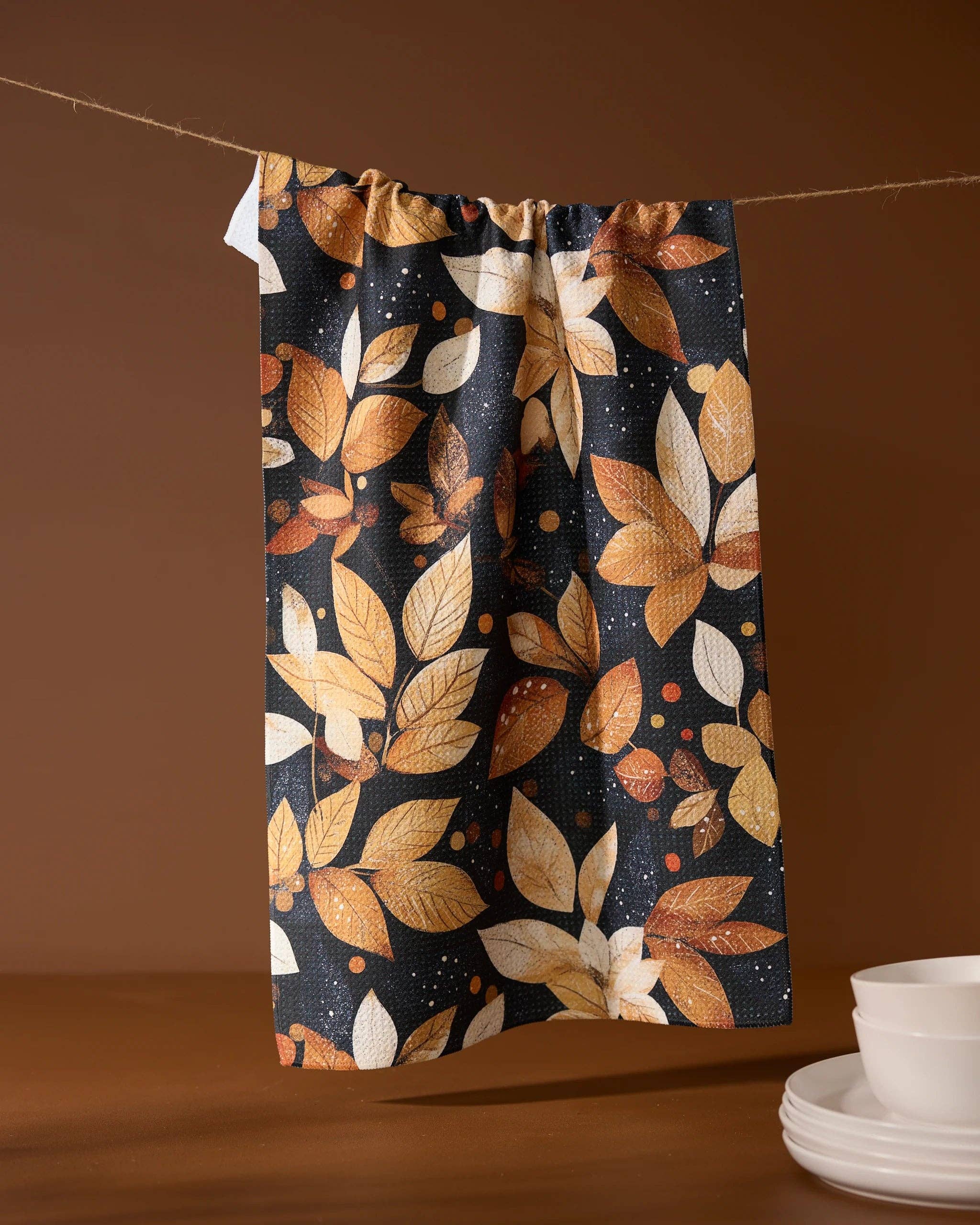 Towel with autumn leaf pattern on a brown background