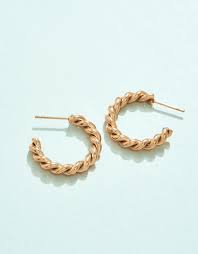 Pair of gold hoop earrings on a light blue background