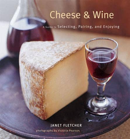 Book cover of 'Cheese & Wine' with a wedge of cheese and a glass of red wine on a wooden board.