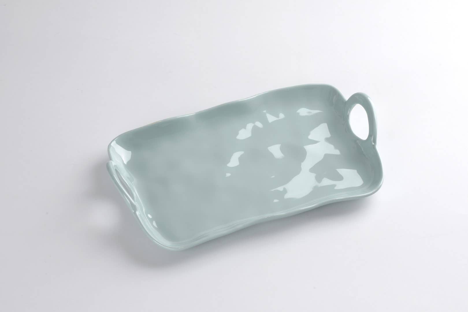 Light blue melamine tray with a handle on a white background