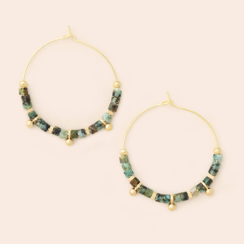 A pair of gold-colored hoop earrings with African turquoise stones and small gold beads.