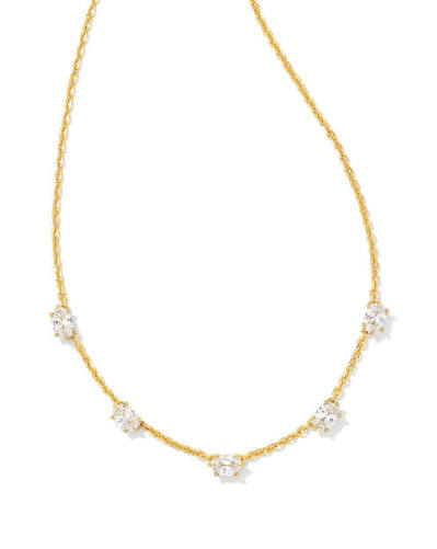 A delicate gold chain necklace featuring five small, clear round-cut gemstones spaced evenly along the chain, set against a plain white background.