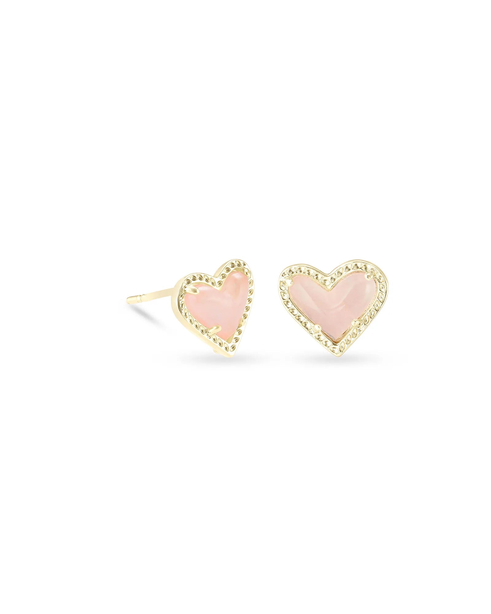 A pair of gold stud earrings with heart-shaped pink inclusions on a white background.
