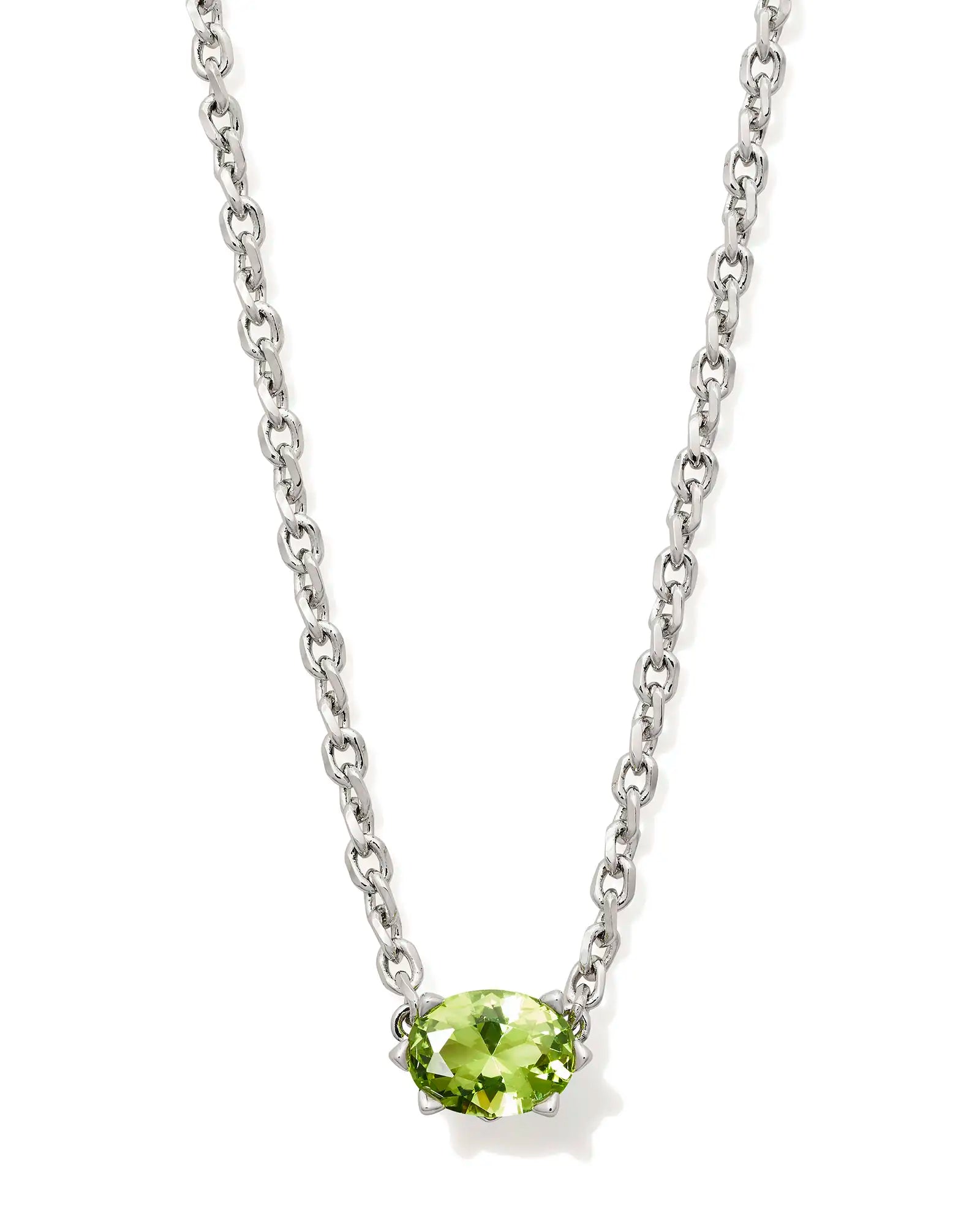Silver necklace with a green gemstone on a white background