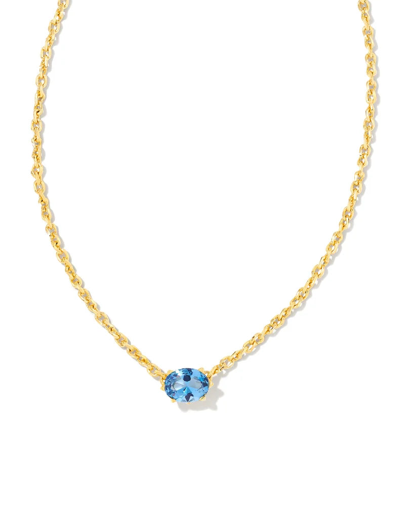 Gold necklace with a blue gemstone on a white background
