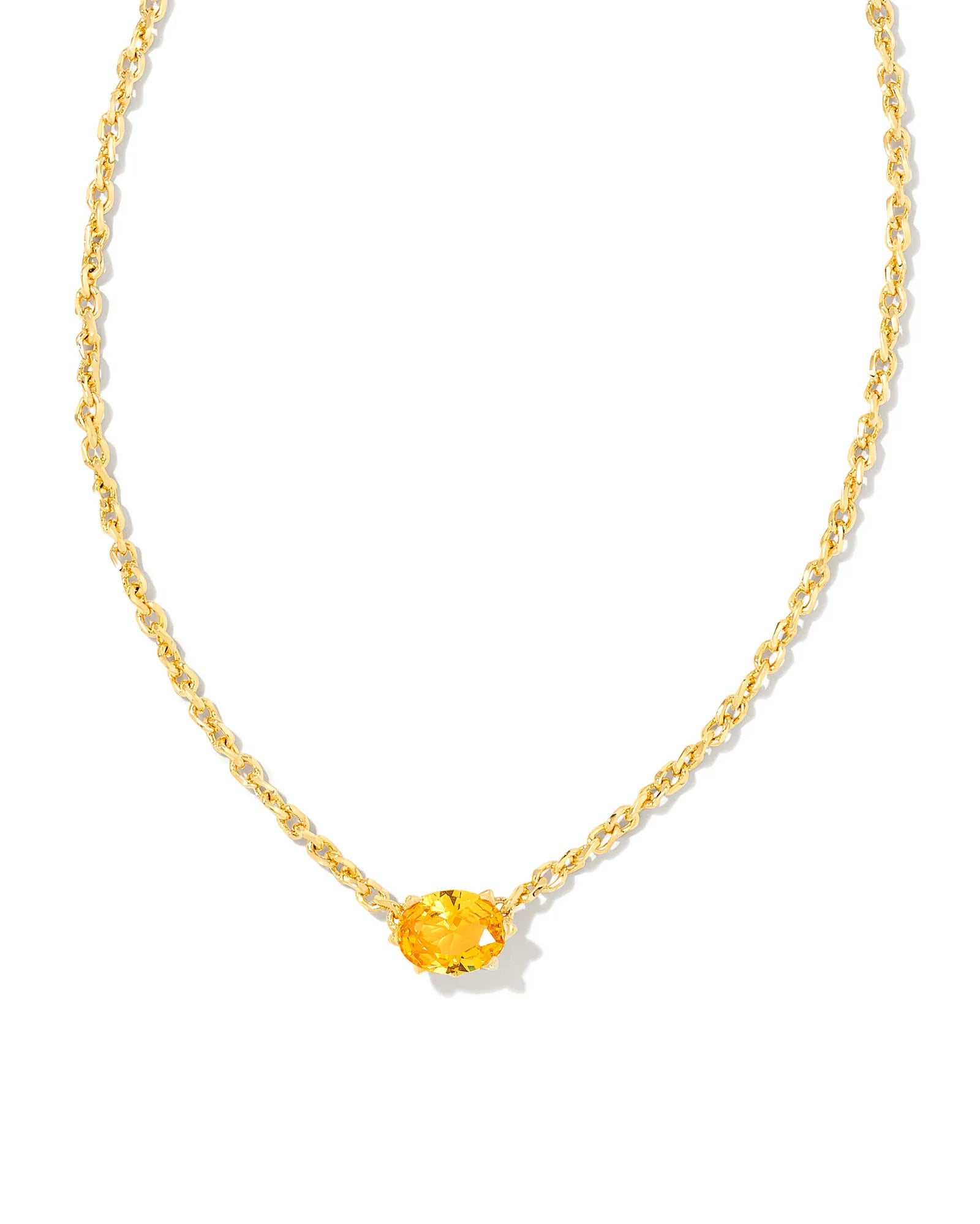 Gold necklace with a yellow gemstone on a white background