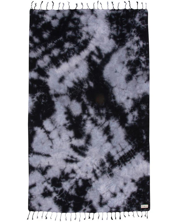A black acid wash beach towel with tie-dye patterns and fringed edges displayed on a white background.