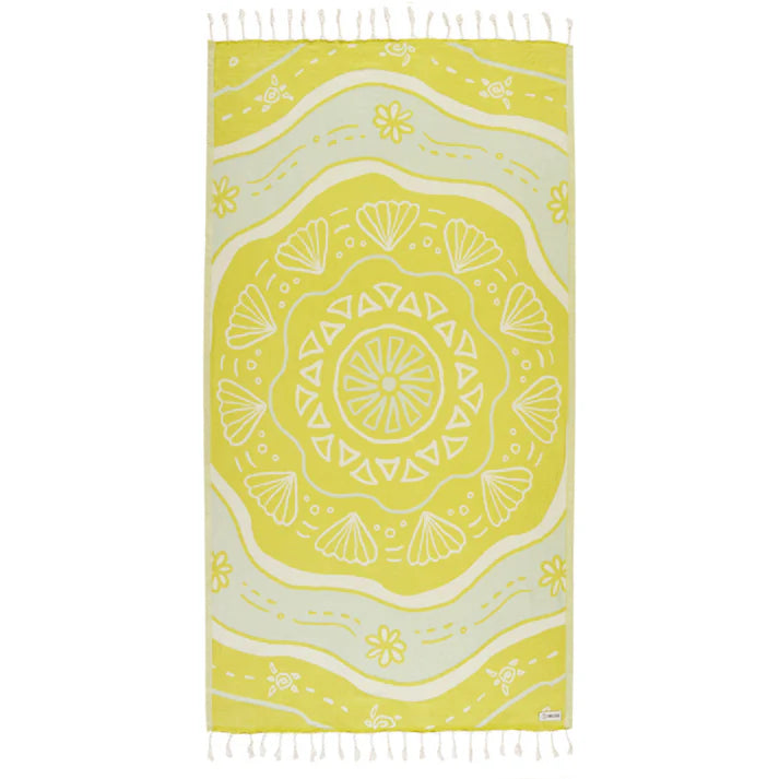 A yellow beach towel with a floral and geometric pattern and white twisted tassels.