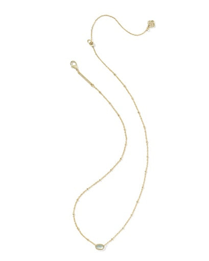 Gold necklace with a small pendant on a white background
