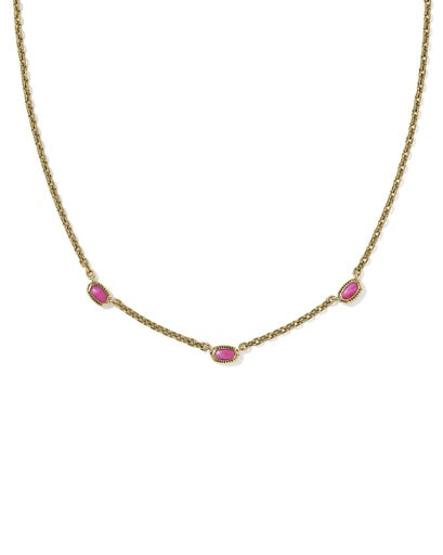 Gold necklace with pink gemstones on a white background