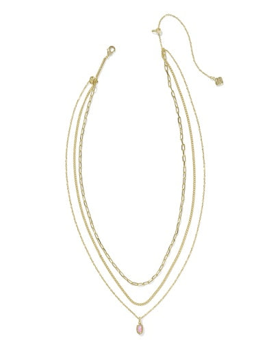 Set of three gold necklaces on a white background