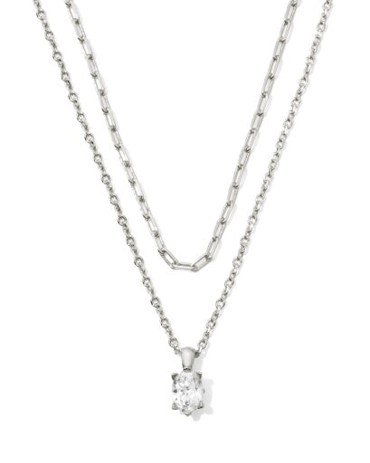 Two silver necklaces with one featuring a diamond pendant on a white background
