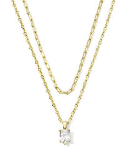 Two gold necklaces on a white background, one with a diamond pendant.