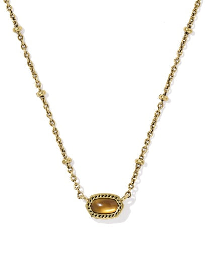 Gold necklace with a tiger's eye pendant on a white background