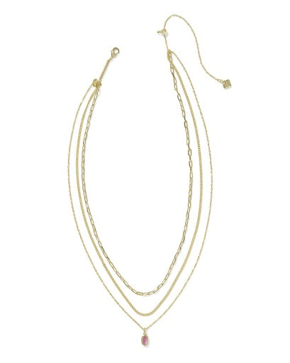 Set of gold necklaces with a pink pendant on a white background