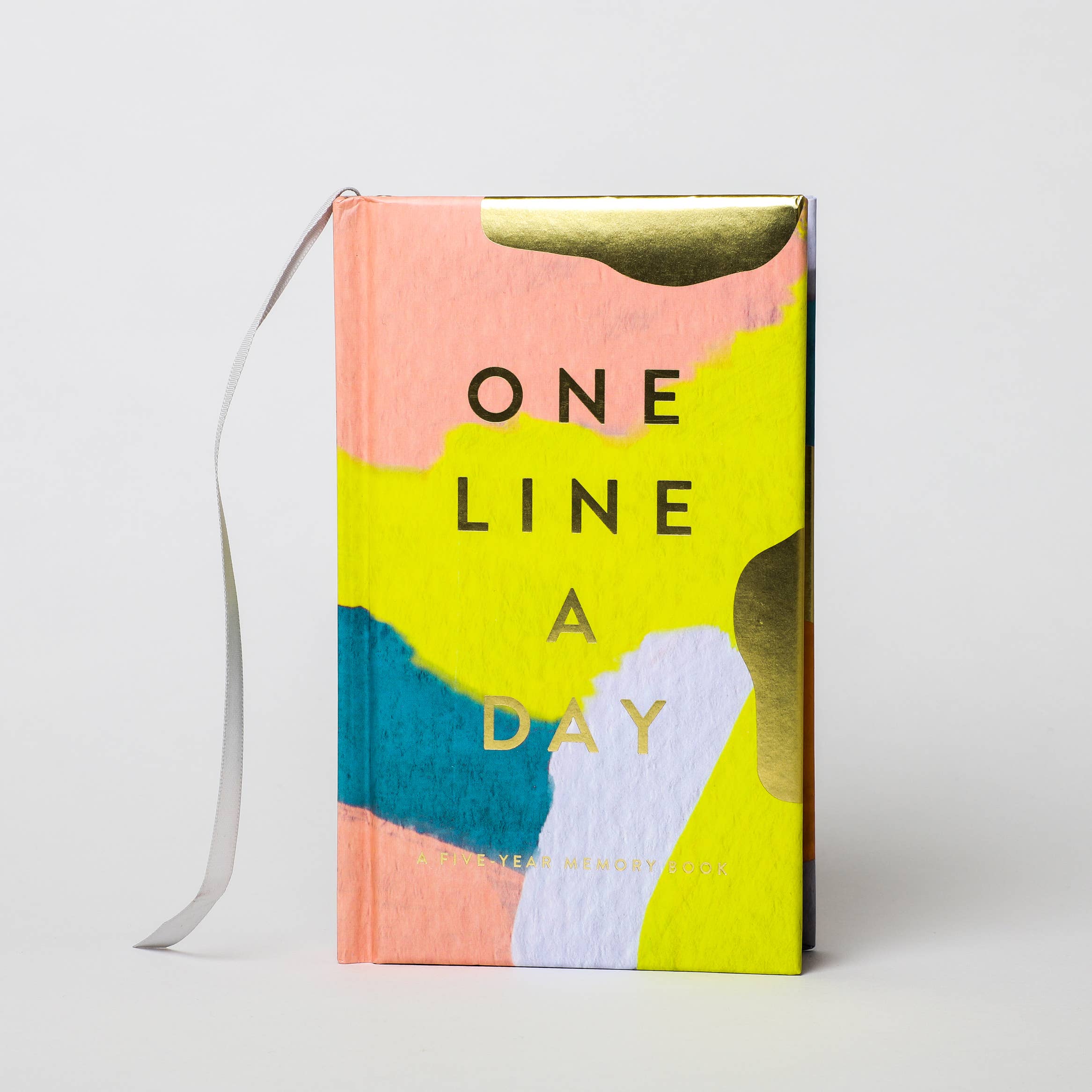 Colorful notebook with 'One Line a Day' text on a white background