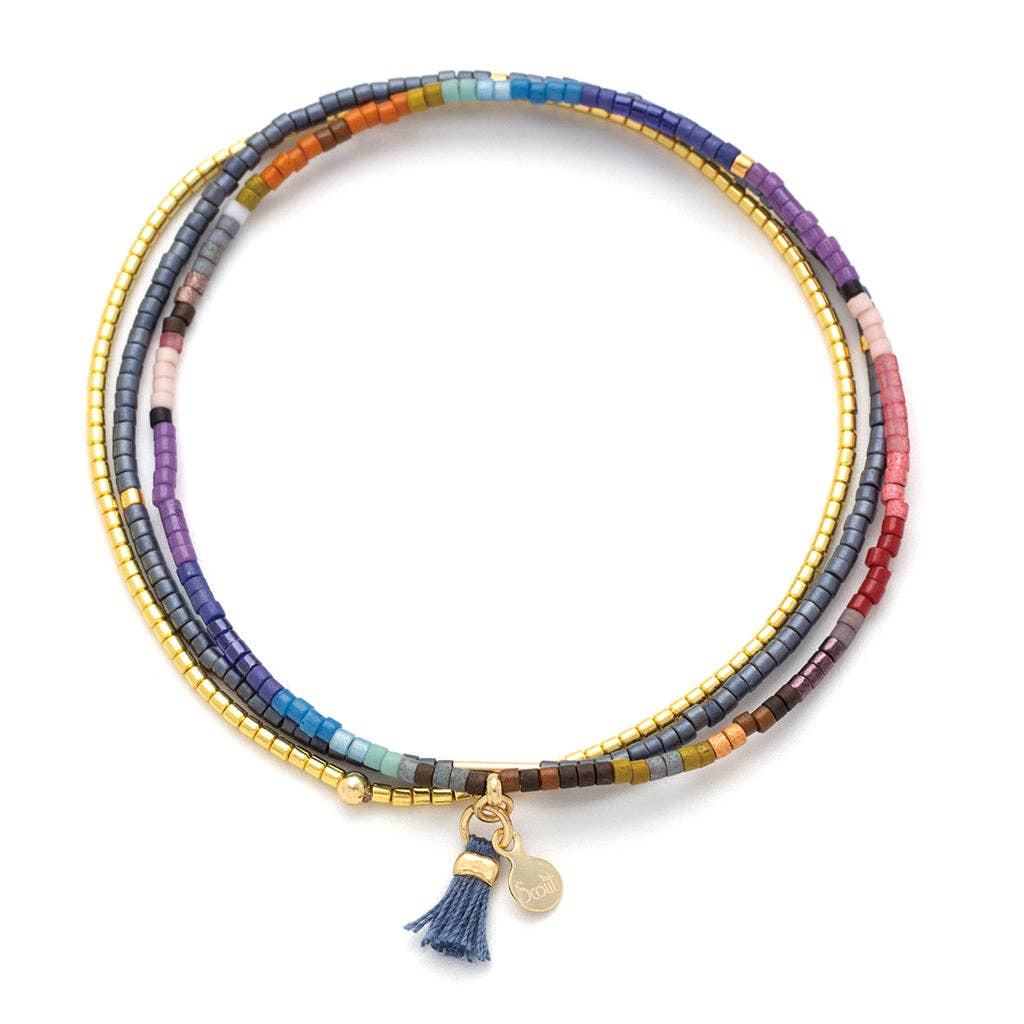 A trio of stackable Miyuki Delica bead bracelets in dark multi and gold colors with gold foil accents, featuring a Scout logo on a thread tassel.