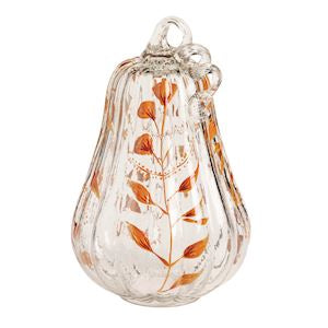 Decorative glass pumpkin with leaf pattern on a white background