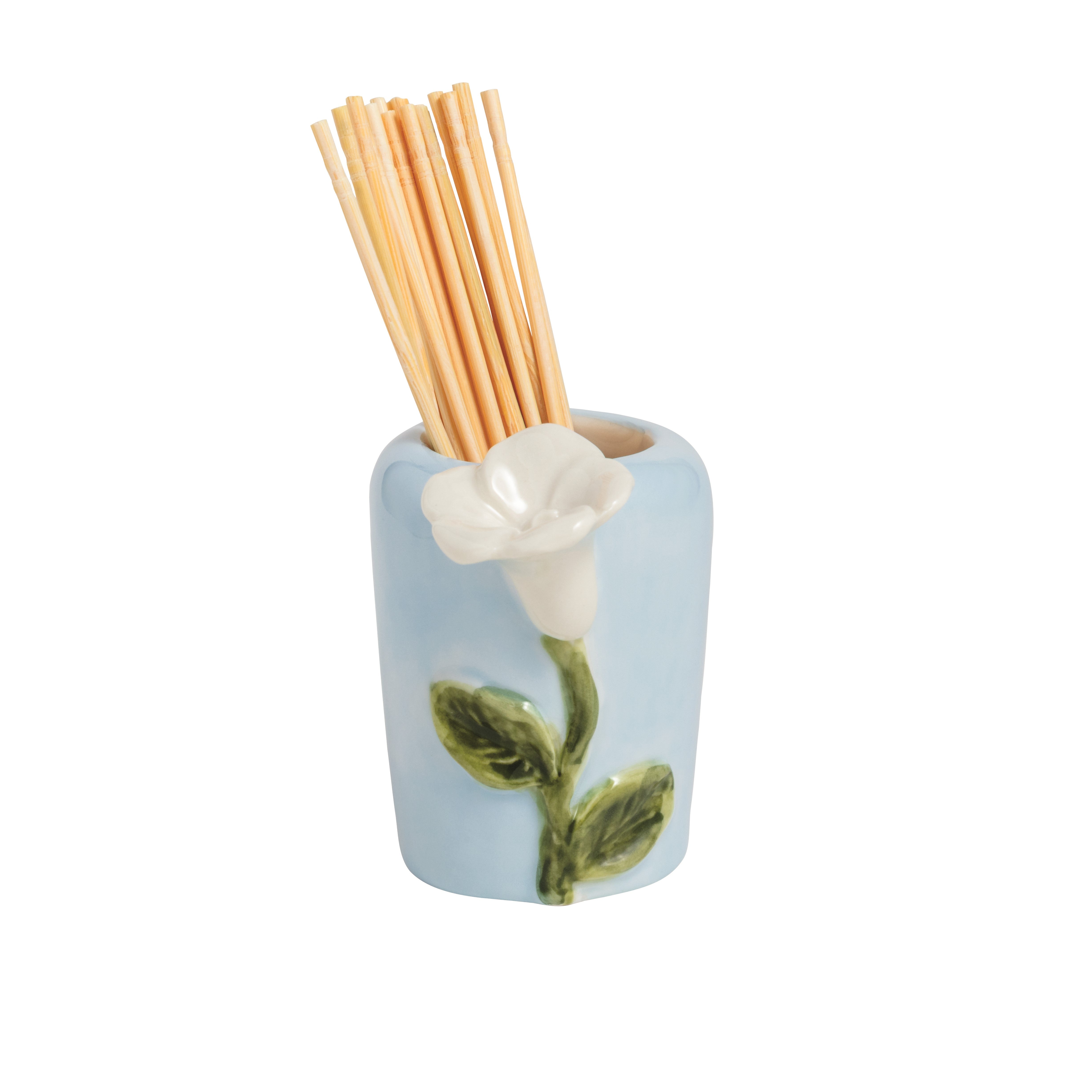 Ceramic holder with white flower design and wooden sticks on a white background